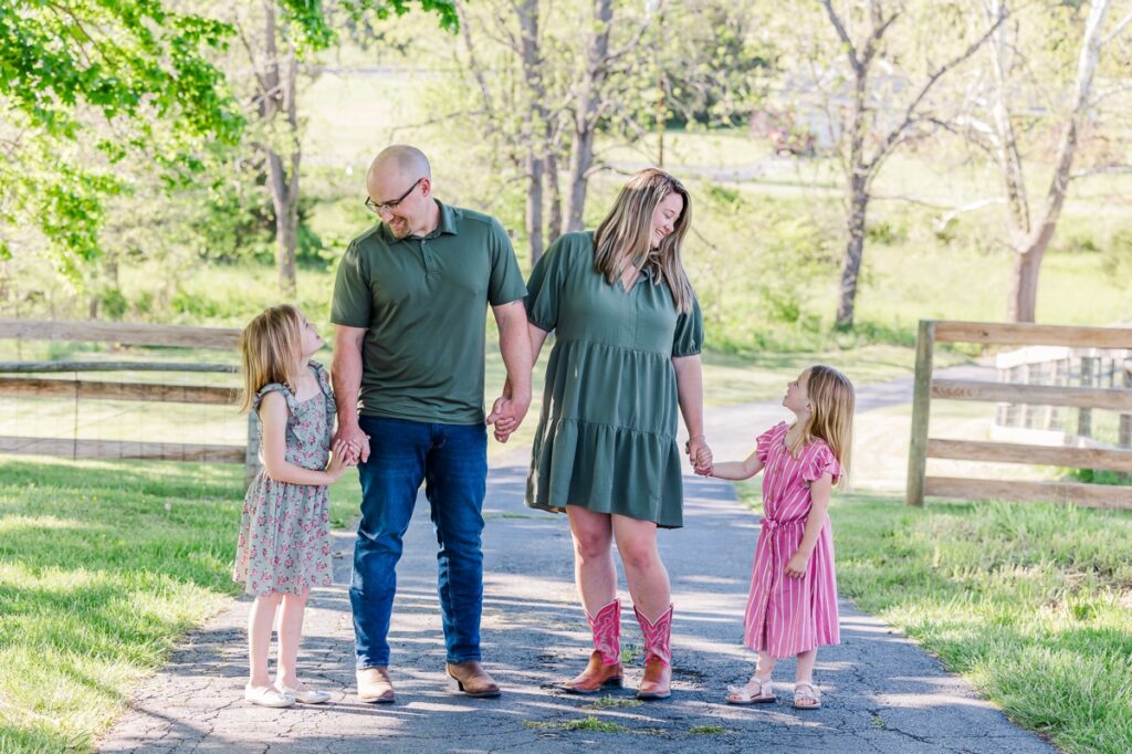 The Rosson family holding hands in a row during their farm family session