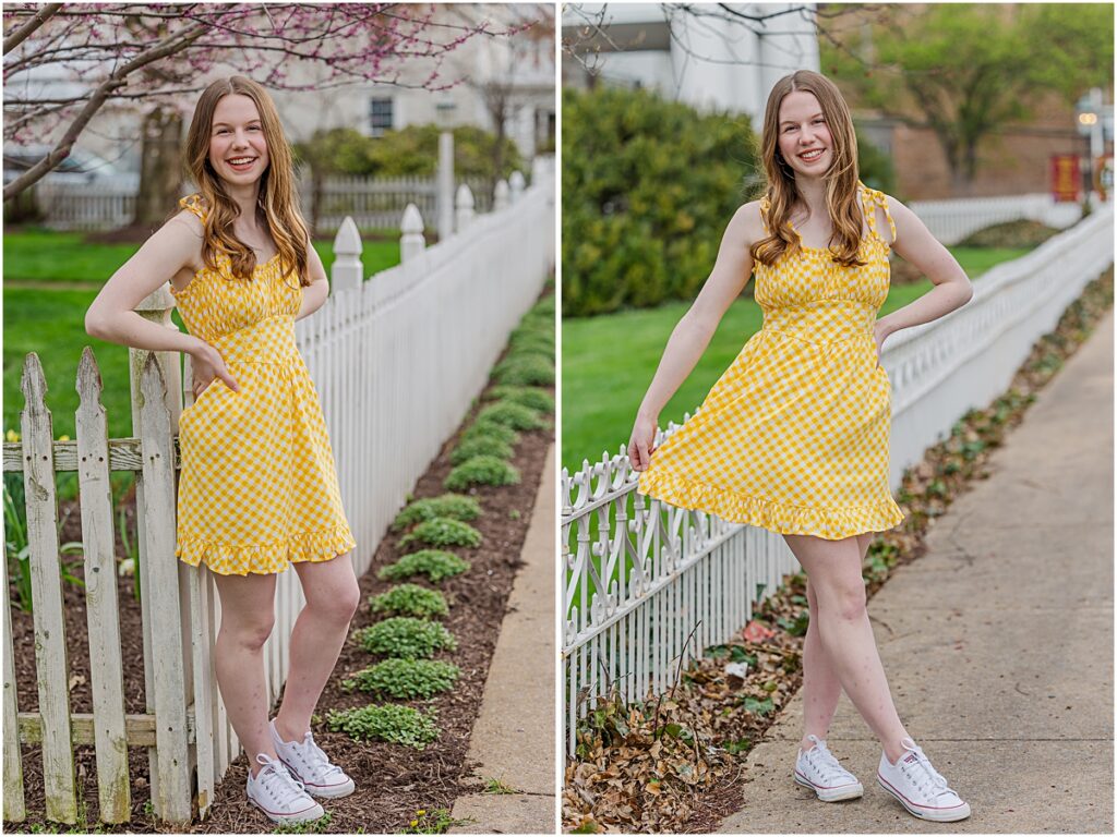 A senior posing by a white fence in a yellow checkered dress illustrating some style options some senior photography tips. 