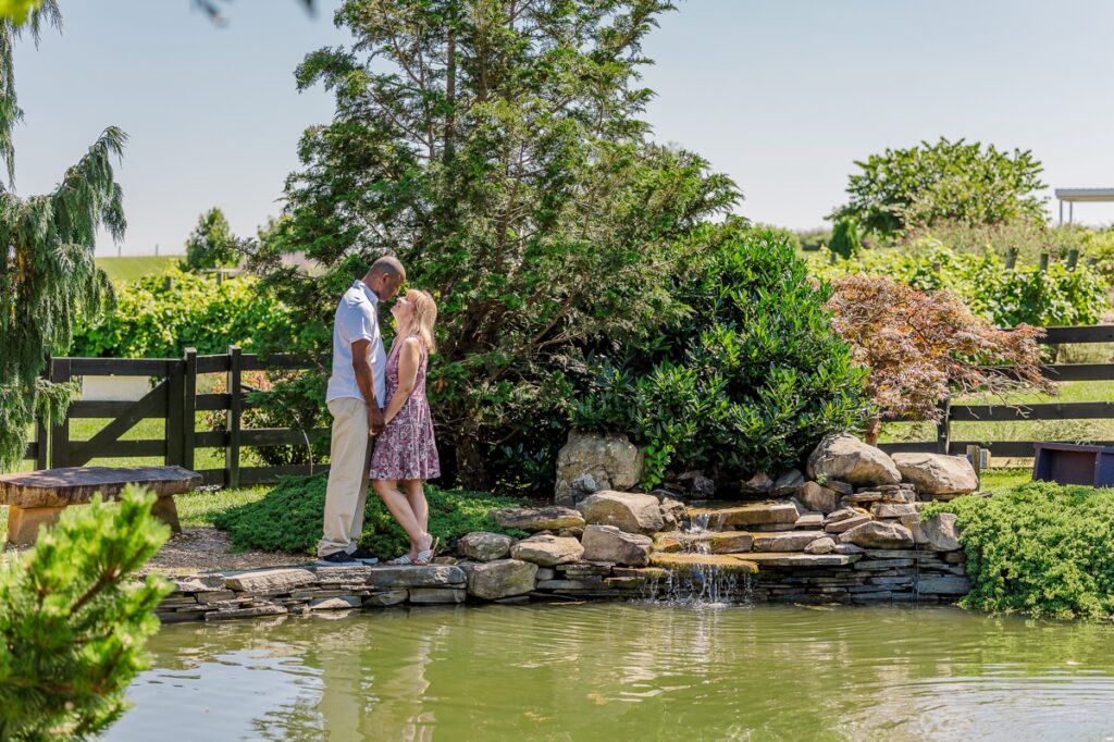 Antonio and Peggy close by the pond and surrounded by lavender captured by their engagement photographer