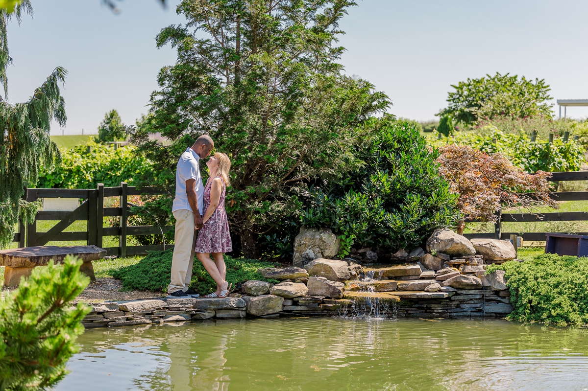 Antonio and Peggy close by the pond and surrounded by lavender captured by an engagement photographer